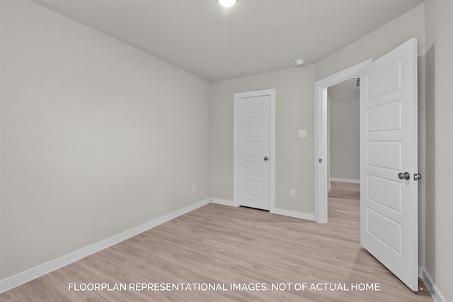 unfurnished bedroom with light wood-style flooring and baseboards