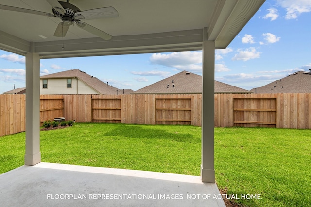 view of yard with a patio area, a fenced backyard, and a ceiling fan