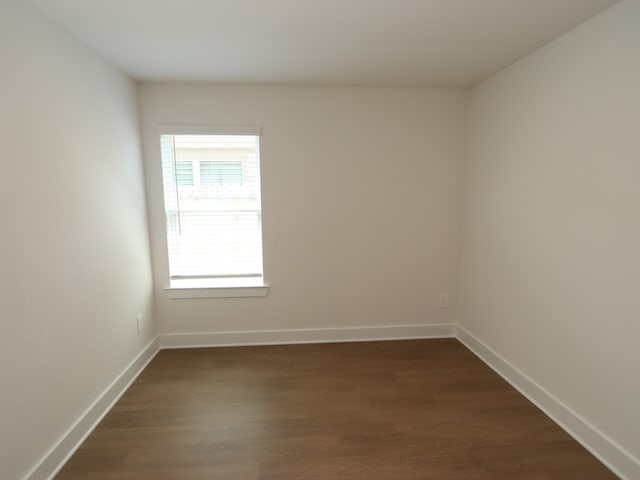 22478 Birchfield Grove Ln, New Caney, TX 77357 - spare room featuring dark wood-type flooring and baseboards