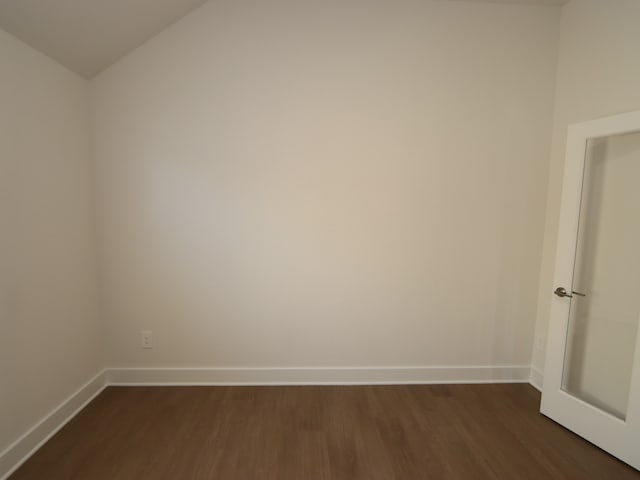 22478 Birchfield Grove Ln, New Caney, TX 77357 - empty room with dark wood-style floors, baseboards, and vaulted ceiling