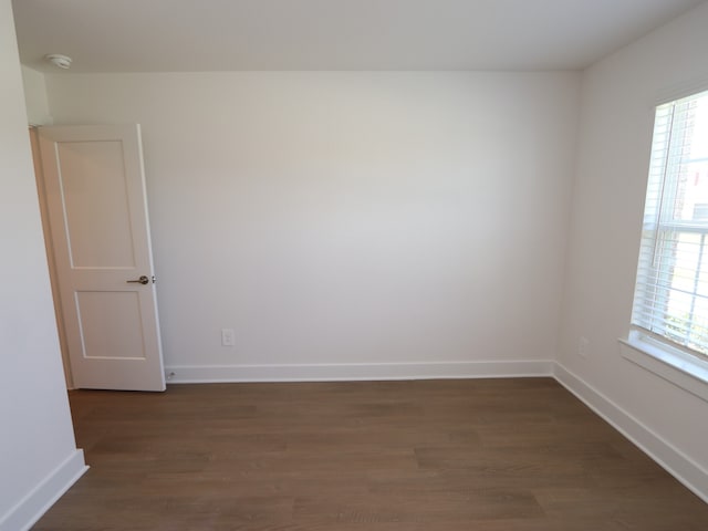 22478 Birchfield Grove Ln, New Caney, TX 77357 - unfurnished room with plenty of natural light, dark wood-type flooring, a smoke detector, and baseboards