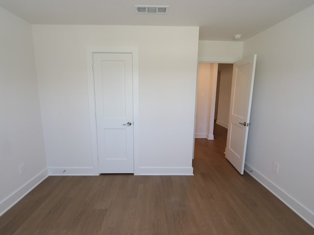 22478 Birchfield Grove Ln, New Caney, TX 77357 - unfurnished bedroom featuring dark wood-style flooring and baseboards