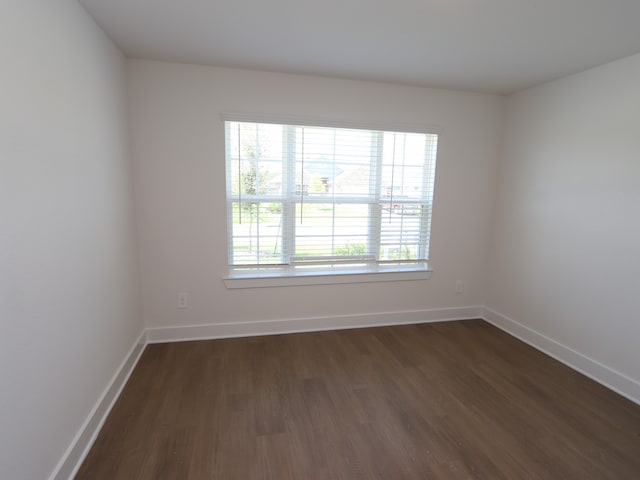 22478 Birchfield Grove Ln, New Caney, TX 77357 - unfurnished room featuring dark wood-style flooring and baseboards