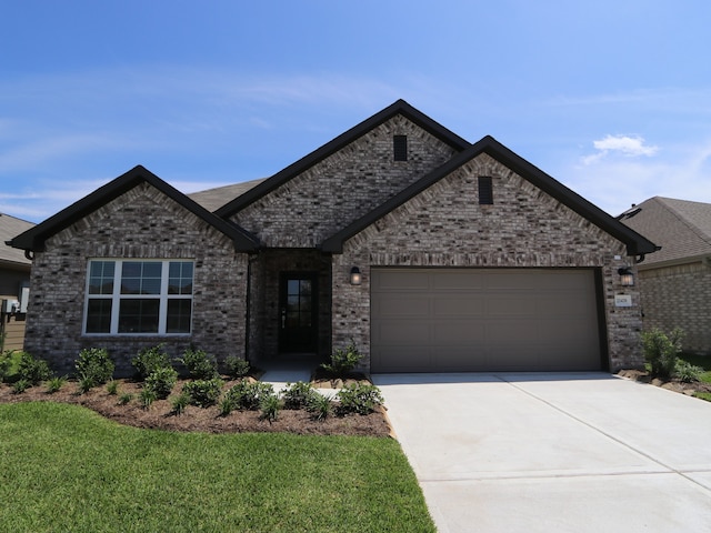 22478 Birchfield Grove Ln, New Caney, TX 77357 - view of front of house featuring driveway, an attached garage, brick siding, and a front yard