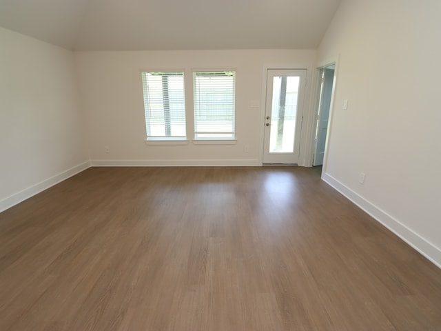 22478 Birchfield Grove Ln, New Caney, TX 77357 - unfurnished room with vaulted ceiling, baseboards, and dark wood-style flooring