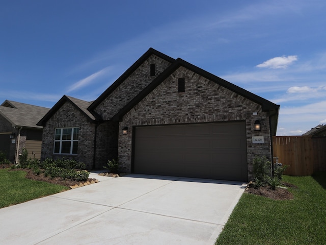 22478 Birchfield Grove Ln, New Caney, TX 77357 - view of front of property with driveway and a garage