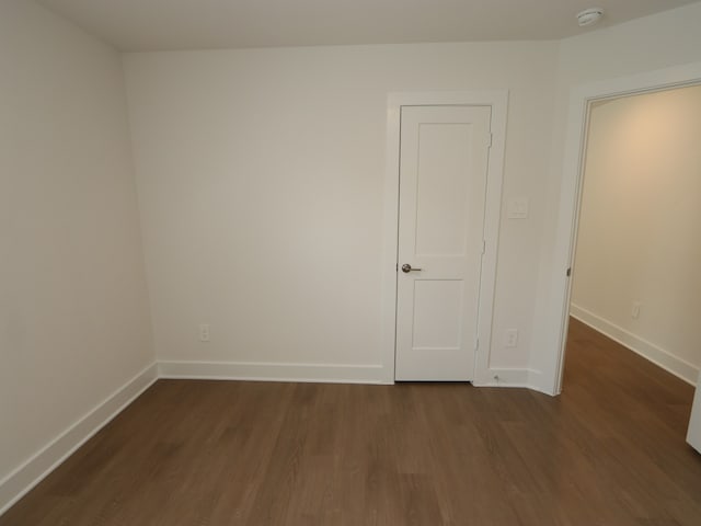 22478 Birchfield Grove Ln, New Caney, TX 77357 - unfurnished bedroom with dark wood finished floors and baseboards