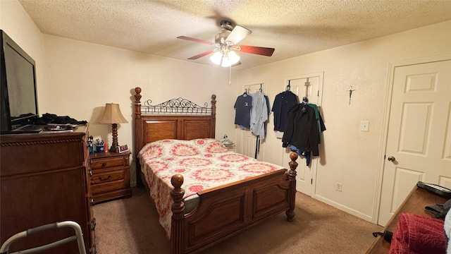 carpeted bedroom featuring ceiling fan and a textured ceiling