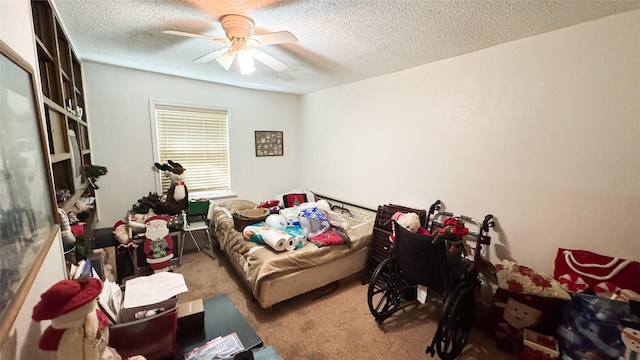 carpeted bedroom with ceiling fan and a textured ceiling