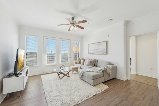 living room with crown molding, dark wood-type flooring, and ceiling fan