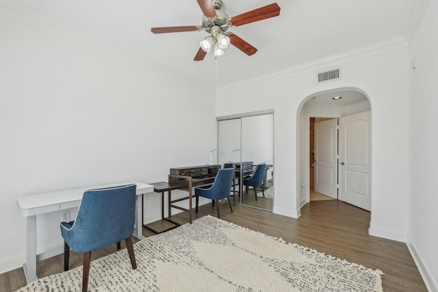 office with crown molding, ceiling fan, and dark hardwood / wood-style flooring