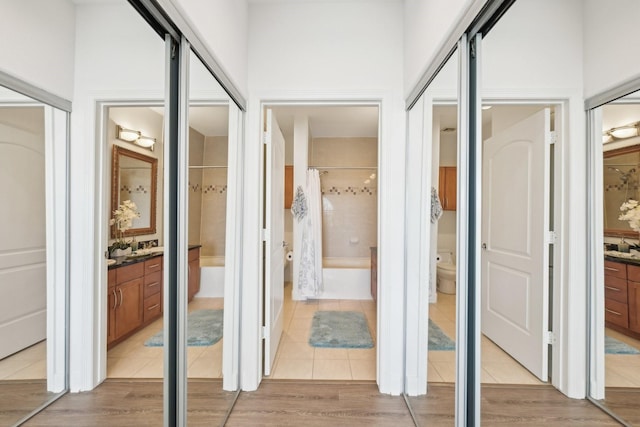 hall with light tile patterned floors