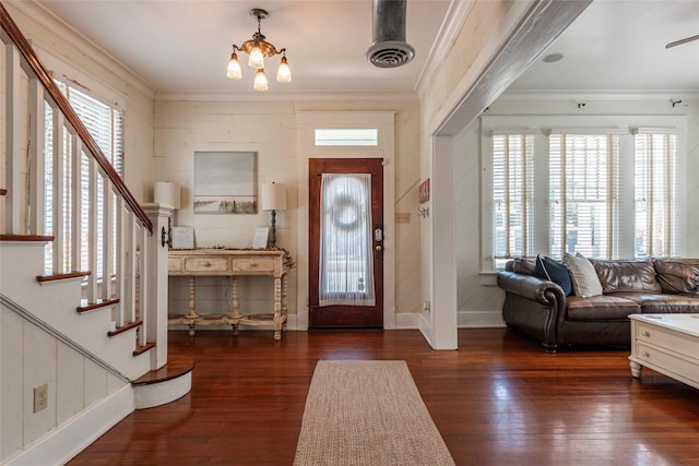 foyer entrance with crown molding, a healthy amount of sunlight, and dark wood-type flooring