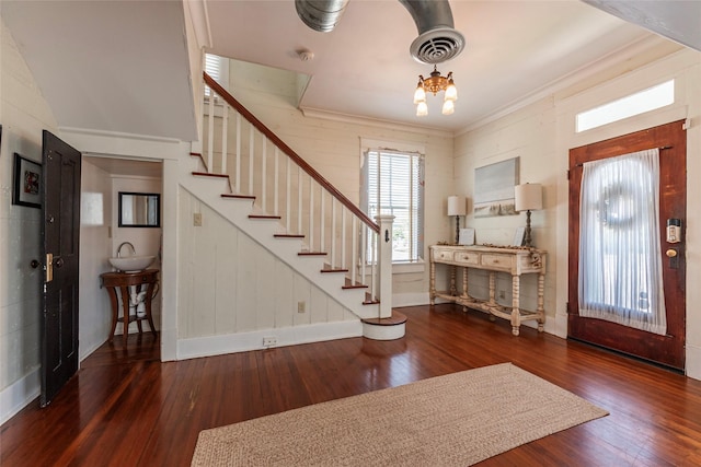 foyer entrance with an inviting chandelier and hardwood / wood-style flooring