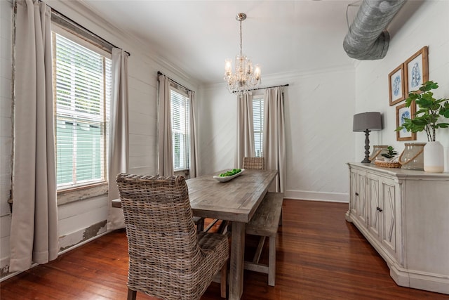 dining space with an inviting chandelier, ornamental molding, and dark hardwood / wood-style floors