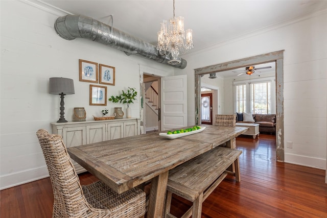 dining room featuring crown molding, dark hardwood / wood-style flooring, and a notable chandelier