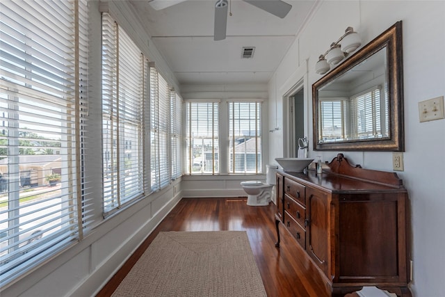 sunroom / solarium with ceiling fan and sink