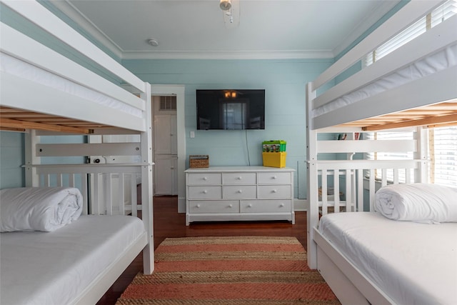 bedroom with crown molding and dark hardwood / wood-style floors