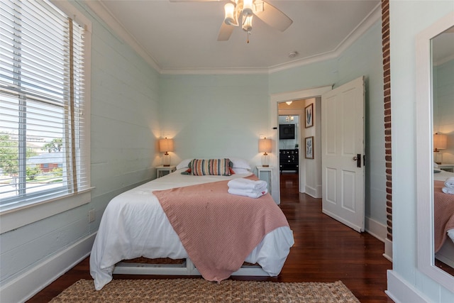 bedroom with dark hardwood / wood-style flooring, ornamental molding, and ceiling fan