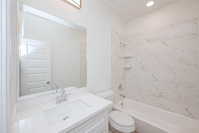 full bathroom with tiled shower / bath, vanity, and toilet