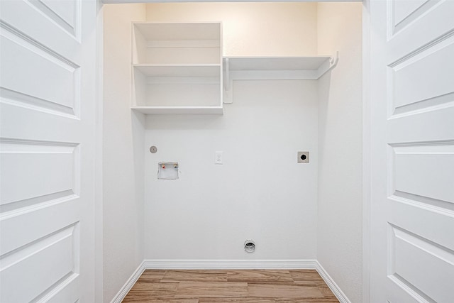 clothes washing area featuring washer hookup, hookup for an electric dryer, and light wood-type flooring