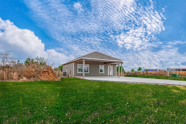 rear view of house with a yard