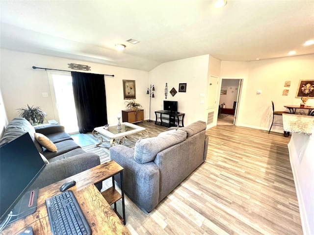 living room with lofted ceiling and light wood-type flooring