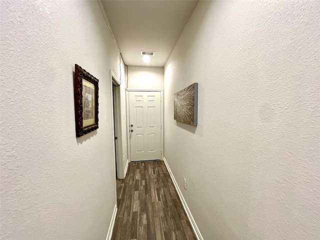 hallway with dark wood-type flooring