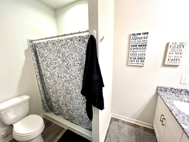 bathroom with wood-type flooring, toilet, a shower with shower curtain, and vanity