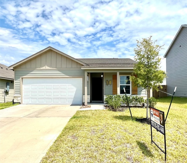 single story home with a garage and a front yard