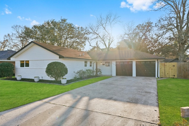 single story home with a garage and a front lawn