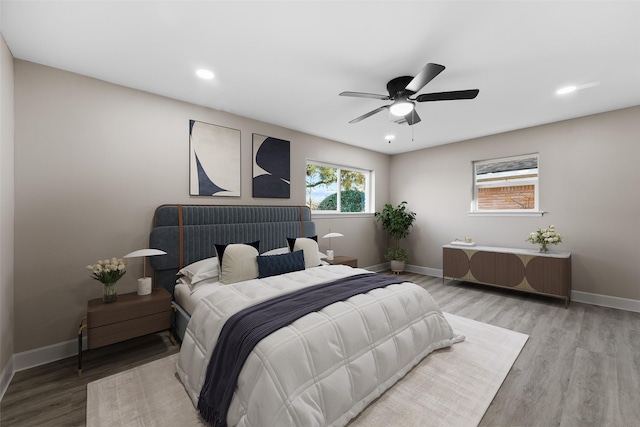 bedroom featuring ceiling fan and light hardwood / wood-style floors