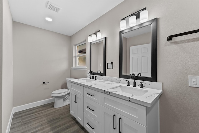 bathroom with vanity, hardwood / wood-style floors, and toilet