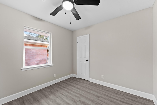 unfurnished room with hardwood / wood-style floors and ceiling fan