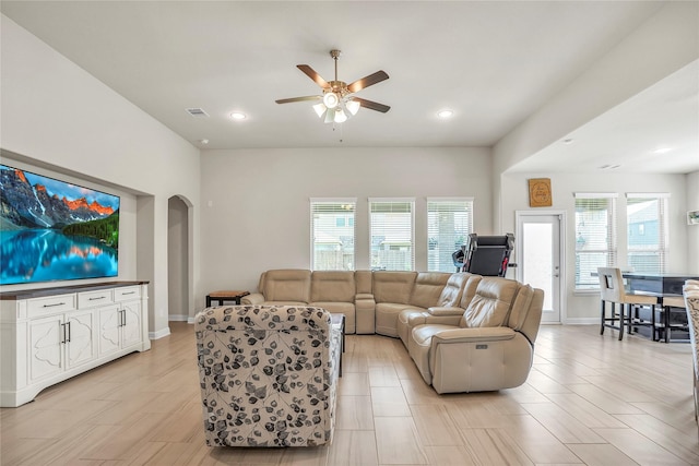 living room featuring plenty of natural light and ceiling fan