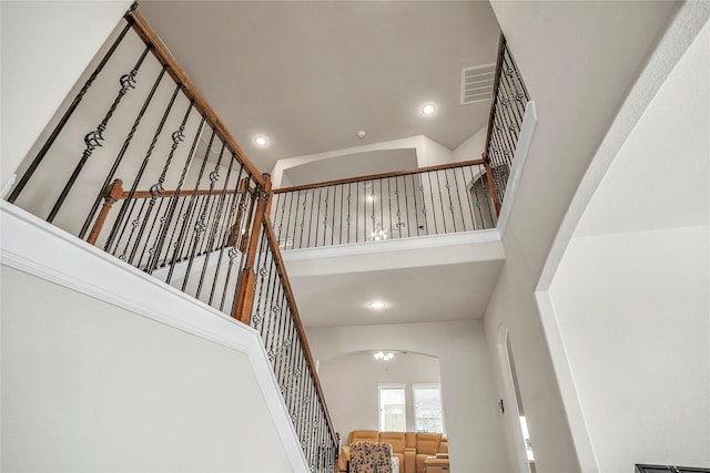 stairway featuring a high ceiling