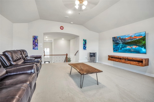 carpeted living room with vaulted ceiling and ceiling fan