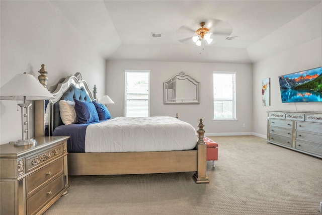 carpeted bedroom featuring ceiling fan, vaulted ceiling, and multiple windows