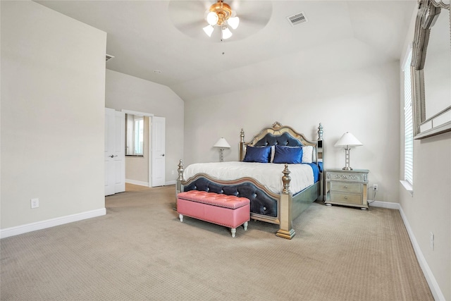 bedroom with ceiling fan, lofted ceiling, and carpet flooring