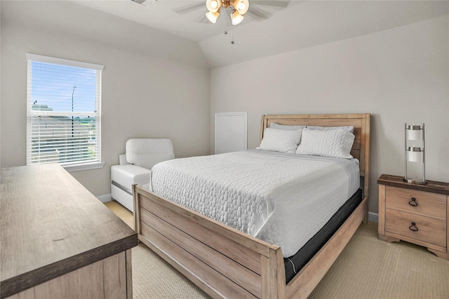 carpeted bedroom with vaulted ceiling and ceiling fan