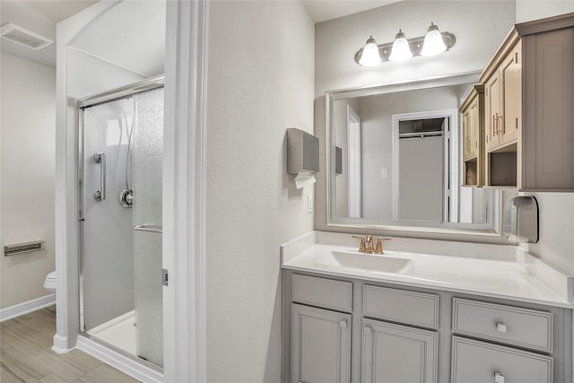 bathroom with vanity, toilet, and an enclosed shower