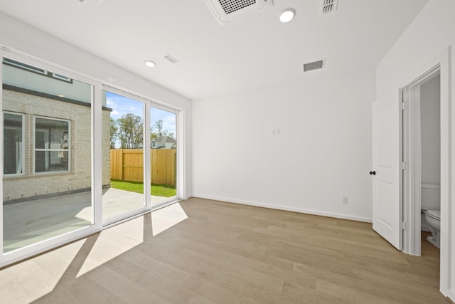 spare room featuring light wood-type flooring