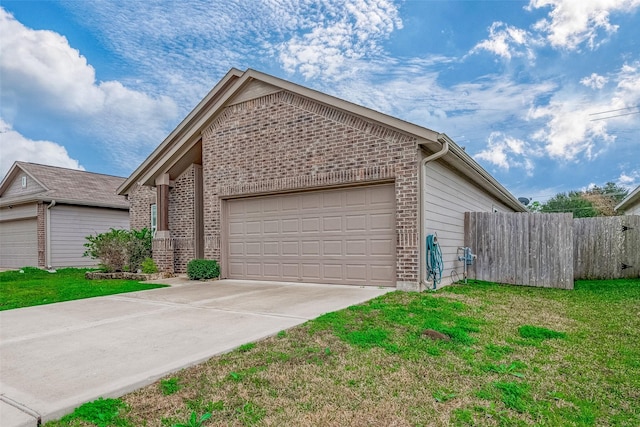 view of front of home featuring a garage and a front lawn