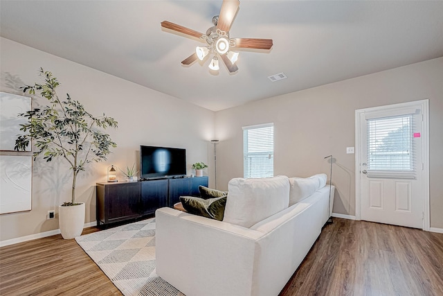 living room featuring ceiling fan and light hardwood / wood-style floors