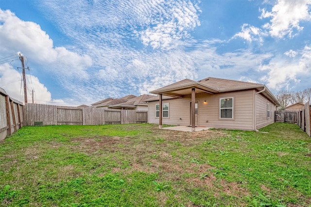 rear view of property featuring a patio area and a lawn