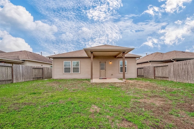 rear view of property with a patio and a yard