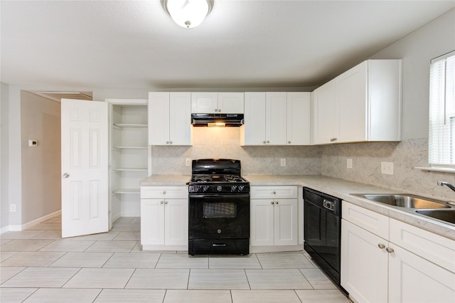 kitchen featuring white cabinetry, a healthy amount of sunlight, sink, and black appliances