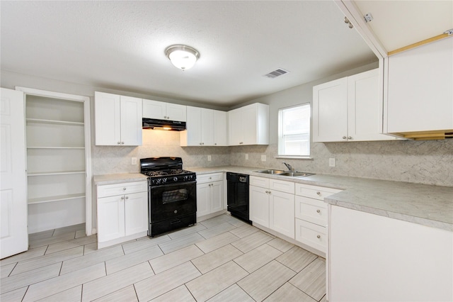 kitchen with white cabinetry, sink, decorative backsplash, and black appliances