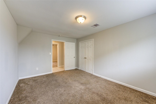 unfurnished room featuring light carpet