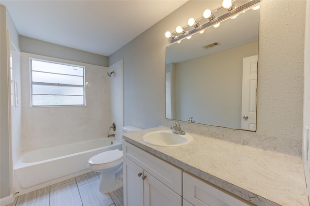 full bathroom with vanity, tiled shower / bath combo, and toilet